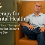 Therapist sitting calmly on a couch representing reflection, emotional awareness, and personal growth in therapy