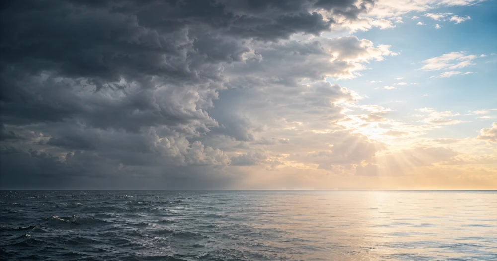 Storm clouds clearing into calm open sky over the ocean, a metaphor for panic easing into relief
